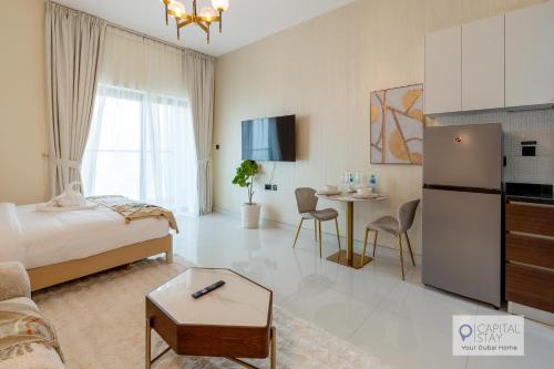 a bedroom with a bed and a living room at Capital Stay - Cozy Studio in Liwan Dubai in Dubai
