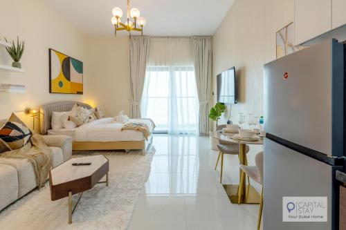 a white living room with a bed and a table at Capital Stay - Cozy Studio in Liwan Dubai in Dubai