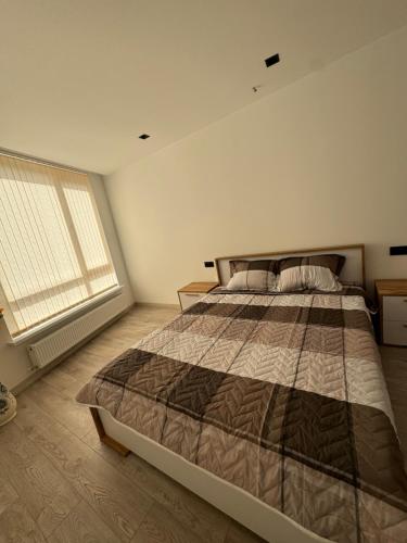 En eller flere senge i et værelse på Gloria Apartment