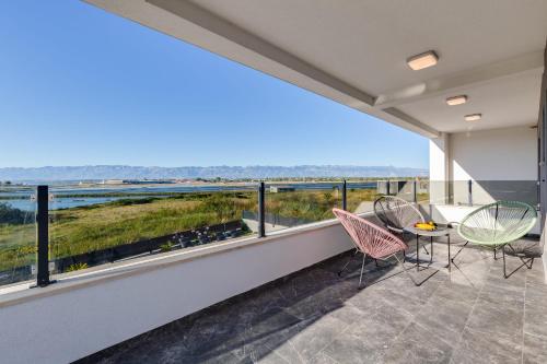 a view from the balcony of a house with a table and chairs at Villa Dona ZadarVillas in Nin