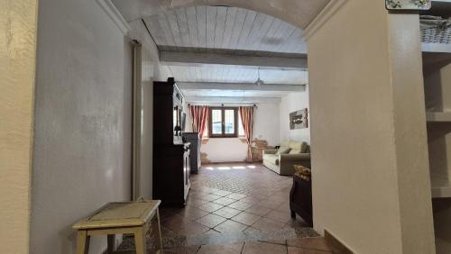 a hallway with a living room with a couch at Da Ziu Beccone in Mamoiada