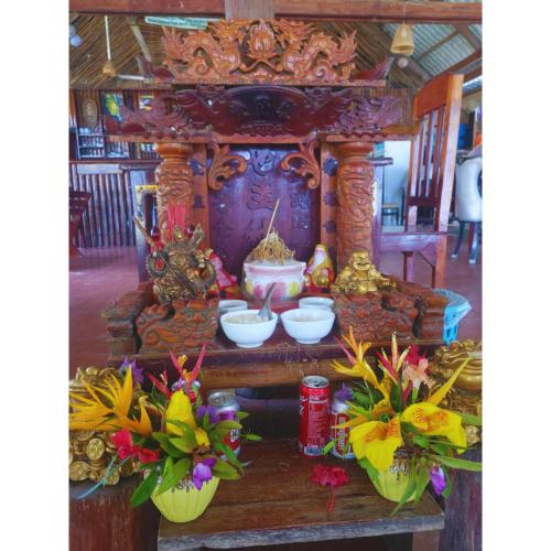 a altar with bowls and flowers in a room at Mangrove Beach Bungalows in Koh Rong Sanloem