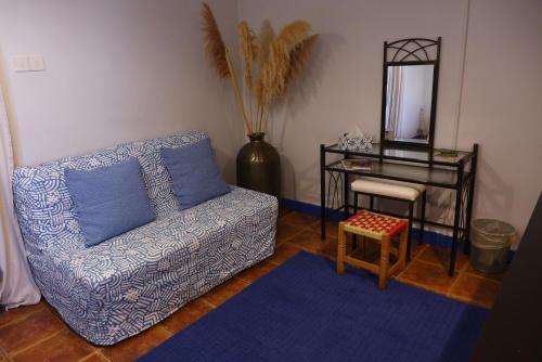a living room with a couch and a table and a mirror at Kalimera A Lovely 1-bedroom rental with ensuite and Kitchen in Limassol