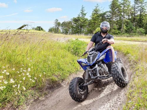 a man riding a dirt bike down a dirt road at Vigsø Holiday Center- Type 7 in Hanstholm
