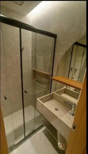 a bathroom with a shower and a sink at Hotel Resort em Salinópolis in Salinópolis