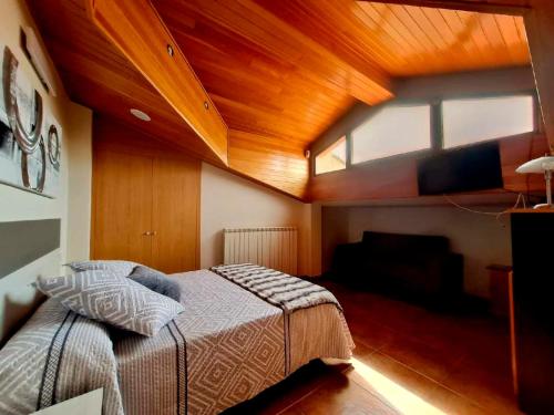 a bedroom with a large bed with a wooden ceiling at Casas Rurales Peña Flor 8 in Carcastillo