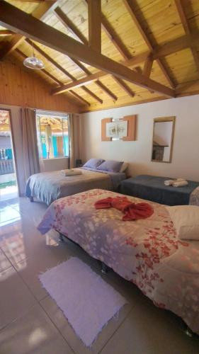 a bedroom with two beds and a basketball hoop at Suítes portal do bosque in Visconde De Maua