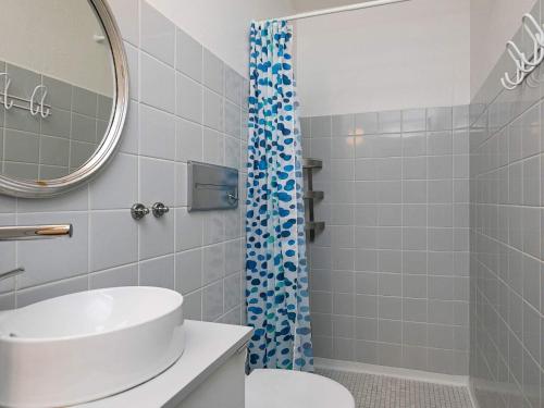 een badkamer met wastafel en douche bij 4 person holiday home on a holiday park in Lemvig in Lemvig
