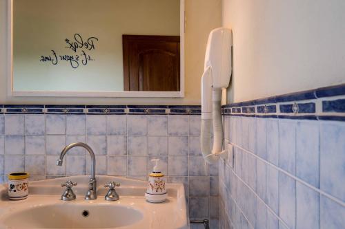 a bathroom with a sink and a phone on the wall at B&B La Casa del Gallese in Sorbolongo