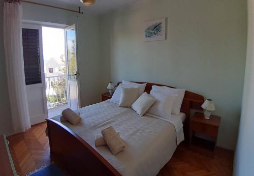 a bedroom with a large bed with two pillows on it at Apartments Mar in Sutivan