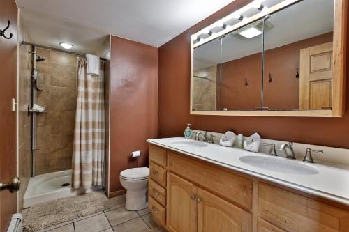 a bathroom with a sink and a toilet and a shower at West Park Chalet - Large Vermont Ski Home - Great for Groups! Hot tub, games, ski rental ticket deals! in Killington