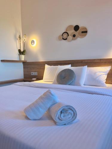a towel on a bed in a hotel room at Areti Guesthouse in Víssani