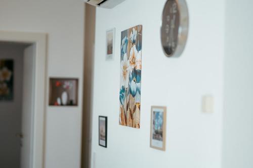 a bunch of pictures hanging on a wall at Danube Rooftop Apartment 15 in Vienna