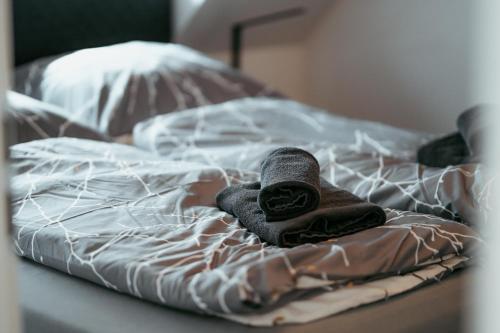 a pair of towels sitting on a bed at Danube Rooftop Apartment 15 in Vienna