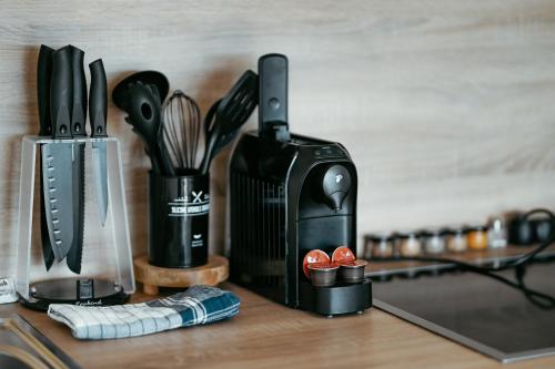 a kitchen counter with a knife block and utensils at Danube Rooftop Apartment 15 in Vienna