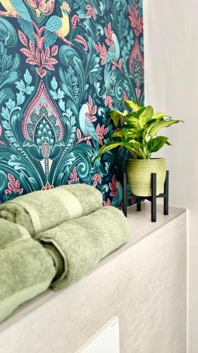 a wall mural with a plant on top of a shelf at Mosel Home Apartments - Netflix - modern & zentral in Schweich