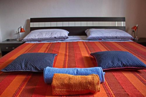 a bedroom with a large bed with two pillows at Apartment Dita in Nin