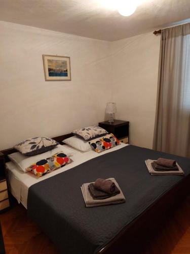a bedroom with two beds with towels on them at Apartment Silvana in Božava
