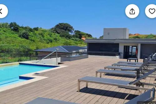une maison avec une piscine et une terrasse dans l'établissement Zimbali Boulevard Suites 203 Beautiful bliss, à Ballito