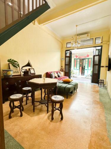 a living room with a couch and a table at The Courtesan at Yaowarat, townhome 80 Sqm in Samphanthawong