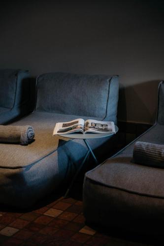 a living room with a couch and a book on a table at Schönherr Haus in Neustift im Stubaital
