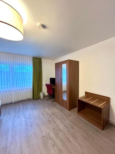 an empty living room with a desk and a table at Waldgasthof Im Schwall in Nastätten