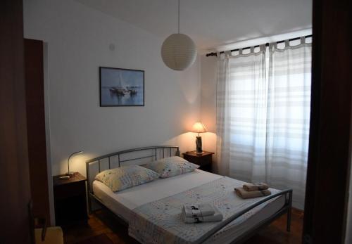 Postel nebo postele na pokoji v ubytování Apartments Ema