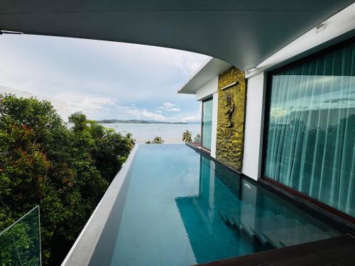 a swimming pool on the side of a house at The Sunrise Ocean Villa 22 in Phuket
