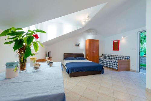 a bedroom with a bed and a couch at Apartments Diana in Dubrovnik