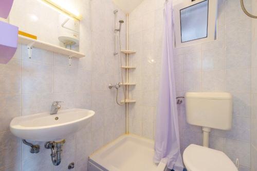 a bathroom with a sink and a toilet and a shower at Apartments Diana in Dubrovnik