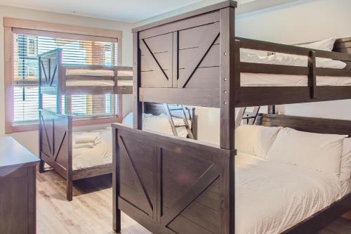 a bedroom with bunk beds in a room at Stonegate Resort Unit B105 in Big White