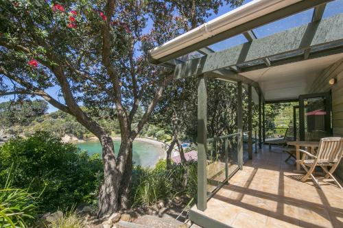 a house with a view of the water at Beachfront Enclosure Bay - Waiheke Unlimited in Oneroa