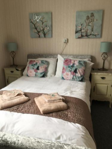 a bedroom with a bed with two towels on it at Whitecliff View in Sandown
