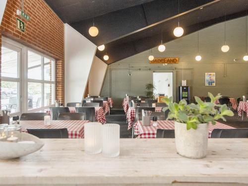 a dining room with a table and chairs at Grand holiday home- Type 11 in Blåvand
