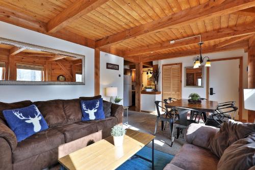 a living room with a couch and a table at The Killington Cabin - Left Unit of Duplex Home - Great for families in Killington