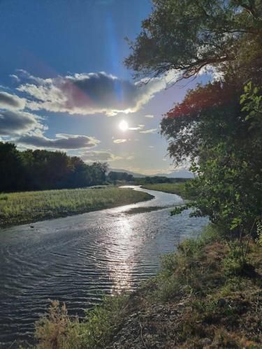 a river with the sun reflecting on the water at Σύγχρονο σπίτι στο χωριό in Lianokládhion