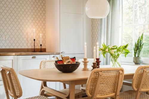 a kitchen with a table with a bowl of fruit on it at Guestly Homes - Charming 3BR House, 2 Full Baths Near City in Piteå
