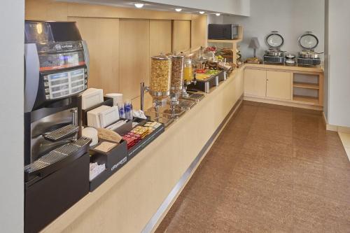 a kitchen with a counter with food on it at City Express by Marriott Culiacan in Culiacán