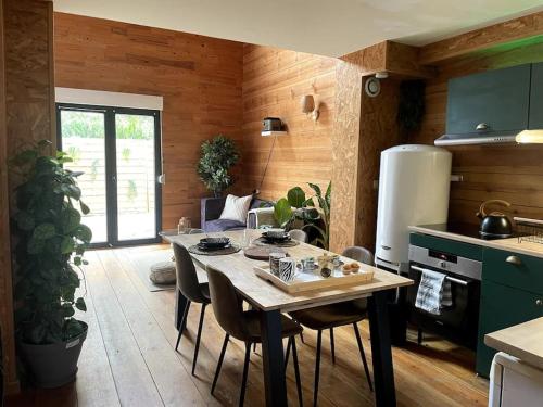 une cuisine avec une table et des chaises dans une pièce dans l'établissement Jungle Suite - Immersion Tropicale, à Cambrai