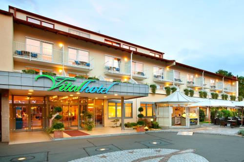 a large building with a restaurant in front of it at Vitalhotel der Parktherme - inkl Thermeneintritt & Sauna in Bad Radkersburg
