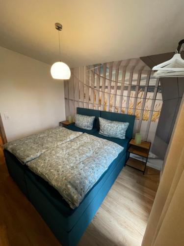 a bedroom with a blue bed and a ladder at Ferienhaus in Ostseenähe für 4 Personen in Rövershagen
