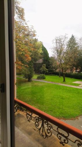 a view of a yard from a window at Chambres d'hôtes au Château Léon in Morvillars