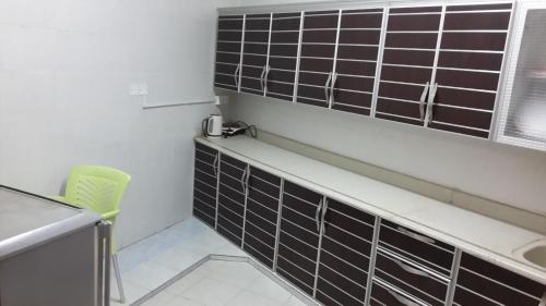 a bathroom with black and white tiles on the wall at Bahget Eljouf Furnished Apartment in Sakakah