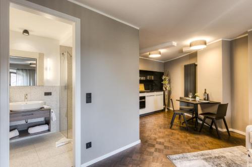 a bathroom and a kitchen with a sink and a table at Studio 9 in Fulda