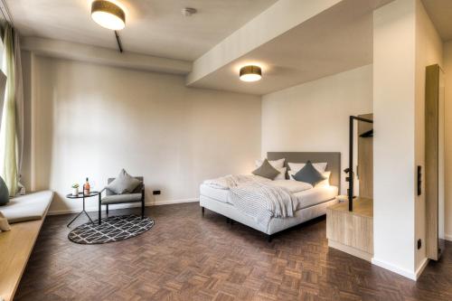 a bedroom with a bed and a chair at Studio 9 in Fulda