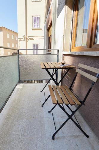 a picnic table and bench on a balcony at B&B La Casa Di Walter in Ascoli Piceno
