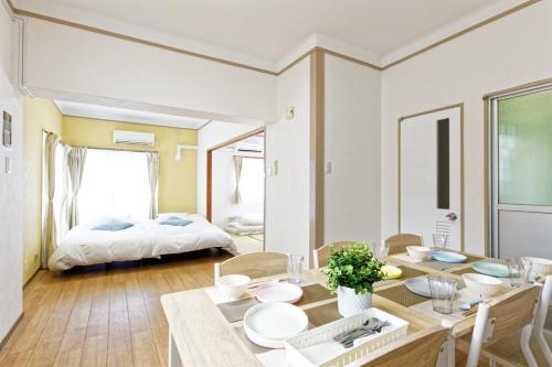 a dining room with a table and a bed at Kurokawa Building No, 201 - Vacation STAY 16198 in Nagoya
