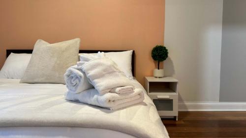 a pile of towels sitting on top of a bed at Private Balcony 1 Garage Parking Sleeps 6 in Chicago