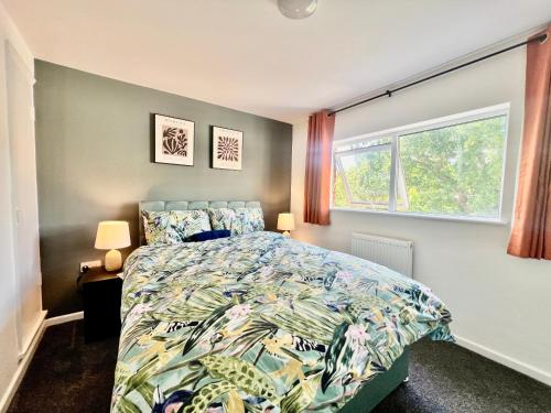 a bedroom with a bed and a window at New!! Refurbished 4 Bedroom House in the Heart of Basildon I Weekly or Monthly Stay Offer I Free Parking I Sleeps 7 in Basildon