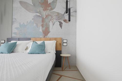 a bedroom with a bed with blue and white pillows at B&B La Casa Di Walter in Ascoli Piceno